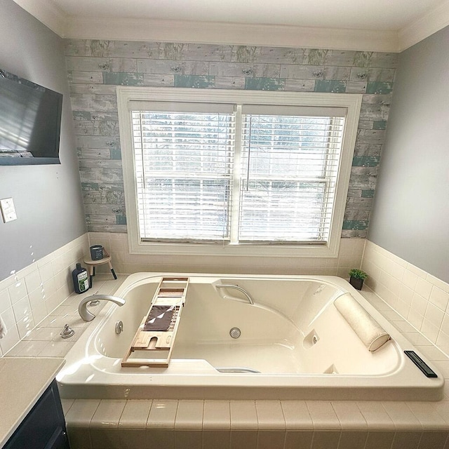 bathroom with tiled bath and ornamental molding