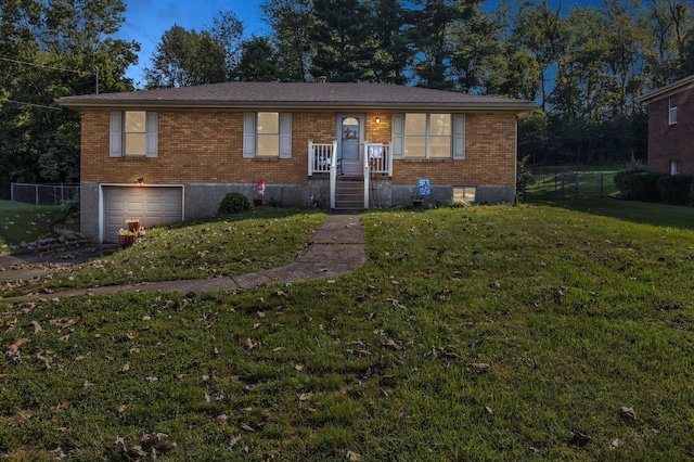 view of front of house featuring a front yard and a garage