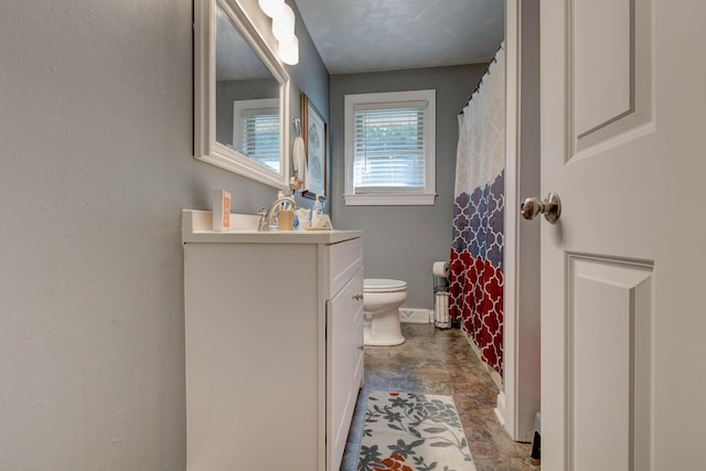 bathroom featuring toilet and vanity