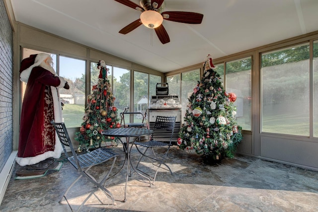 sunroom with ceiling fan and lofted ceiling