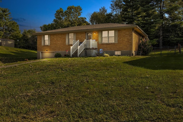 ranch-style home featuring a front lawn and a garage