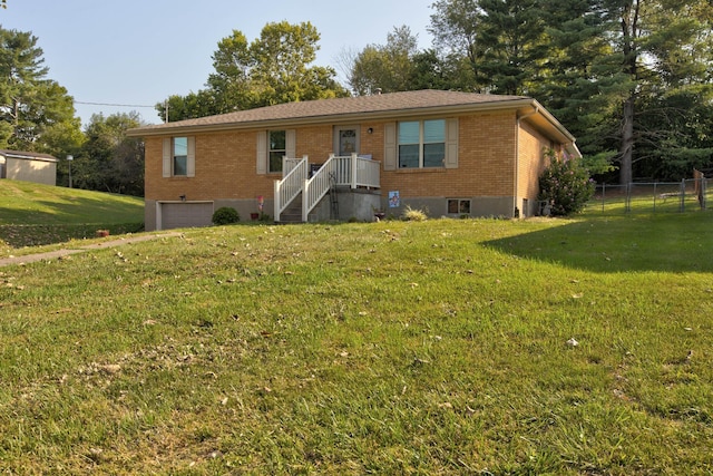 ranch-style home with a front yard and a garage