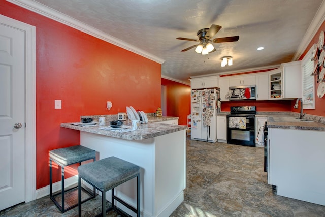 kitchen featuring white refrigerator, white cabinets, kitchen peninsula, range with two ovens, and a breakfast bar