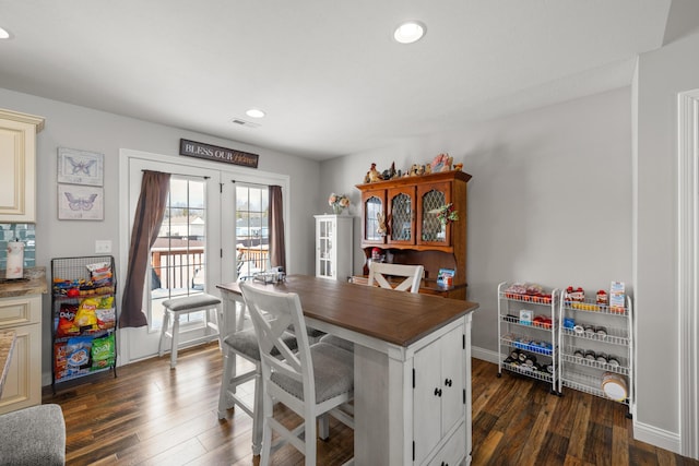 kitchen with french doors, dark hardwood / wood-style flooring, and a breakfast bar area