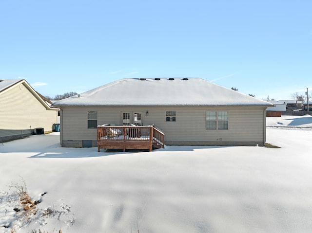 snow covered house featuring a deck