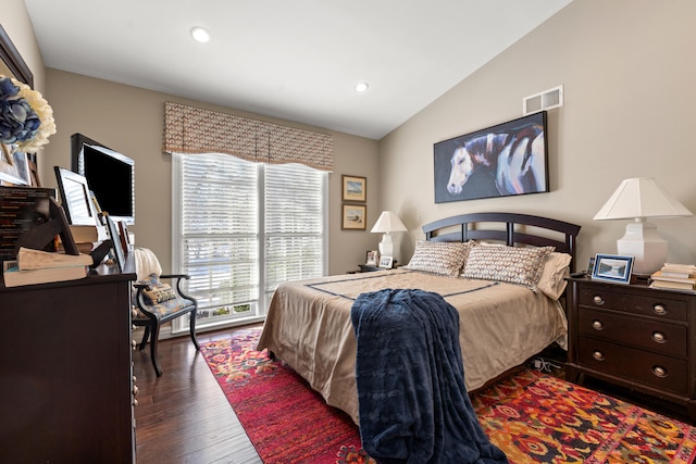 bedroom with lofted ceiling and dark wood-type flooring