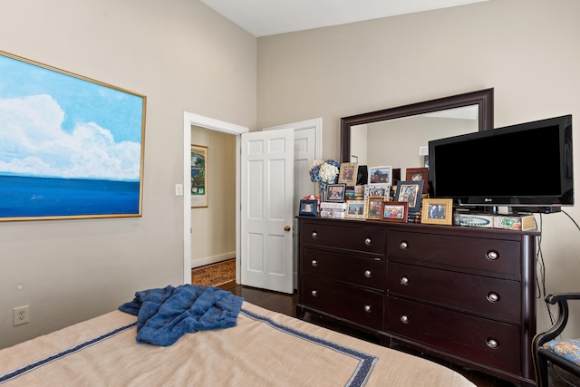 bedroom with dark wood-type flooring