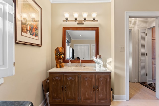 bathroom with vanity and ornamental molding