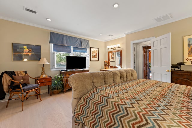 bedroom featuring ornamental molding and light hardwood / wood-style flooring