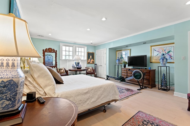 bedroom with light wood-type flooring and crown molding