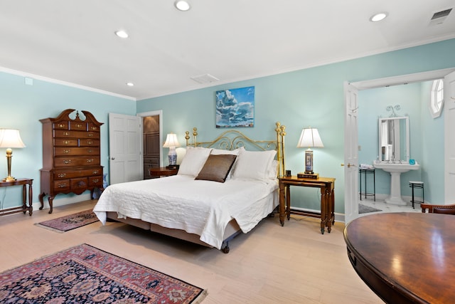 bedroom with light hardwood / wood-style floors and crown molding