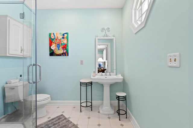 bathroom featuring toilet and a shower with door