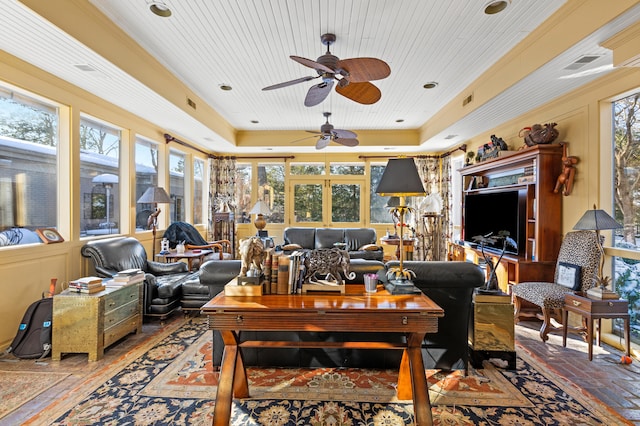 living room featuring ornamental molding, ceiling fan, a tray ceiling, and wood ceiling