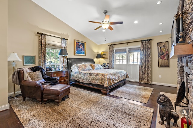 bedroom featuring ceiling fan, vaulted ceiling, multiple windows, and hardwood / wood-style flooring