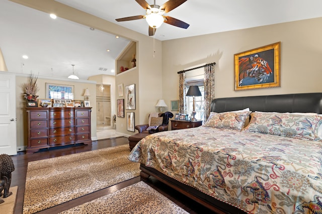 bedroom with ceiling fan, dark hardwood / wood-style flooring, ensuite bathroom, and vaulted ceiling