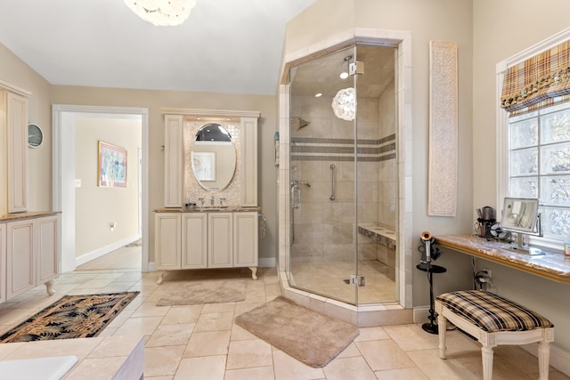 bathroom with lofted ceiling, tile patterned flooring, a shower with shower door, and vanity