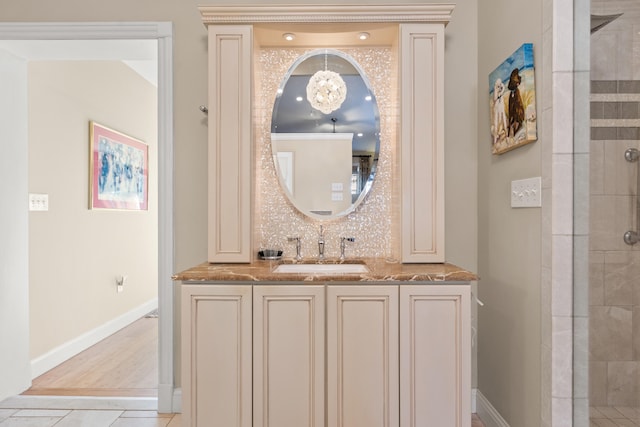 bathroom featuring tile patterned flooring, an enclosed shower, tasteful backsplash, and vanity