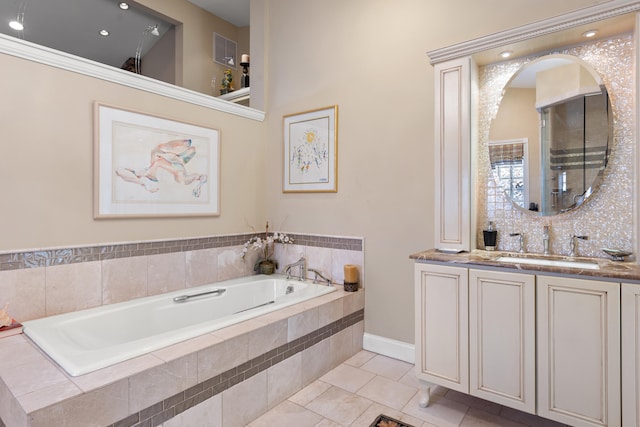 bathroom featuring vanity, tiled tub, and tile patterned floors