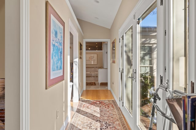 doorway featuring light hardwood / wood-style floors, french doors, and lofted ceiling