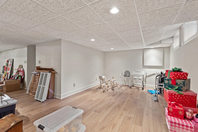 rec room with a paneled ceiling and wood-type flooring