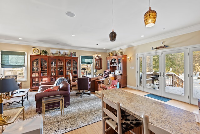 interior space featuring a notable chandelier, french doors, crown molding, and light hardwood / wood-style flooring