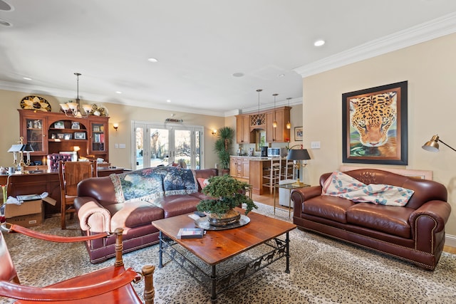 living room with crown molding and a notable chandelier