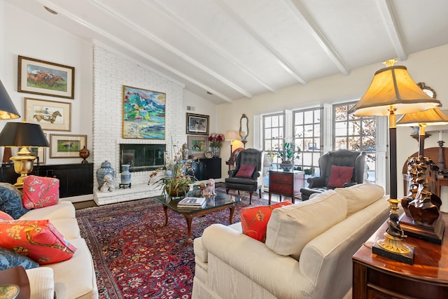 living room featuring vaulted ceiling with beams and a fireplace