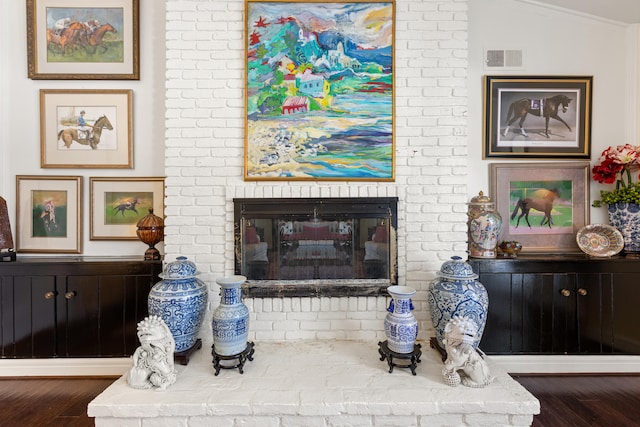 sitting room with a fireplace, vaulted ceiling, and dark wood-type flooring