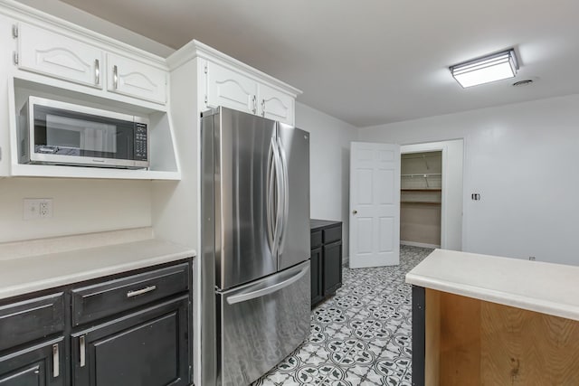 kitchen with white cabinets and appliances with stainless steel finishes