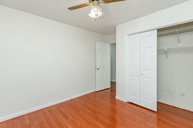 unfurnished bedroom with ceiling fan and wood-type flooring