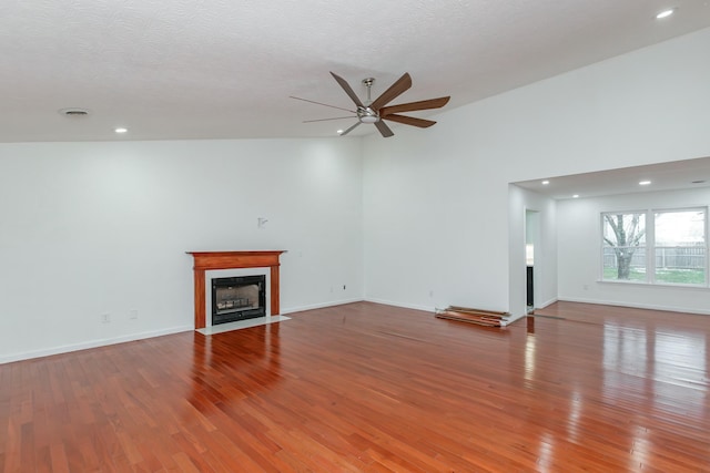 unfurnished living room featuring ceiling fan and wood-type flooring