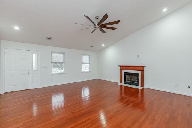 unfurnished living room with lofted ceiling, ceiling fan, and hardwood / wood-style flooring