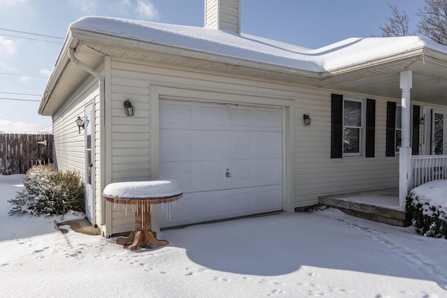 snow covered property featuring a garage