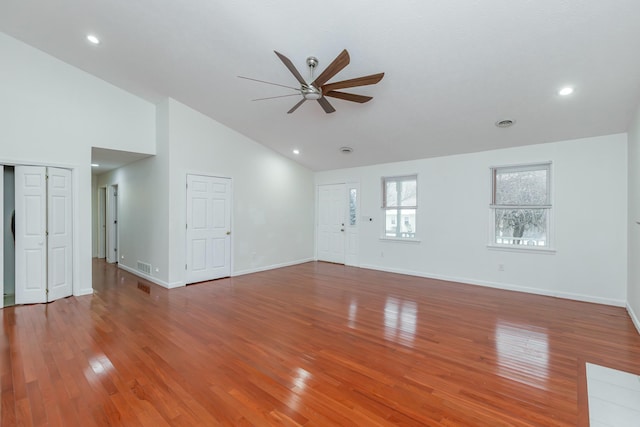 unfurnished living room with ceiling fan, hardwood / wood-style floors, and high vaulted ceiling