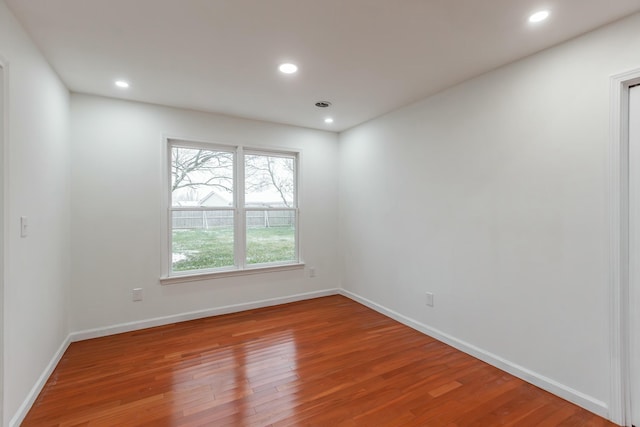 spare room featuring wood-type flooring