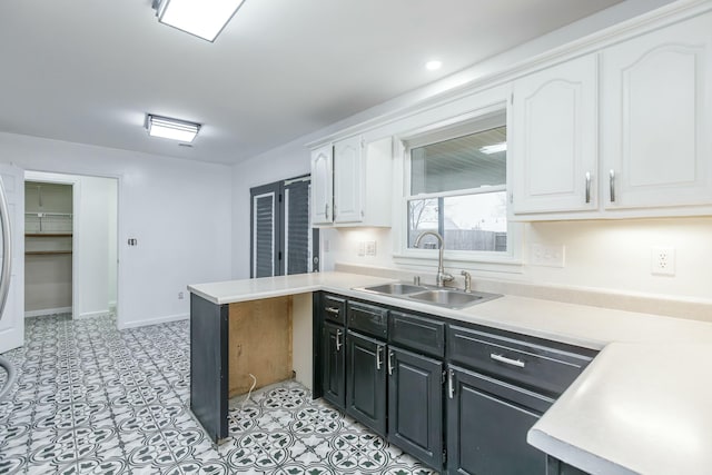 kitchen with white cabinetry and sink