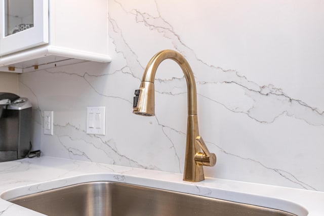 interior details with sink and white cabinetry