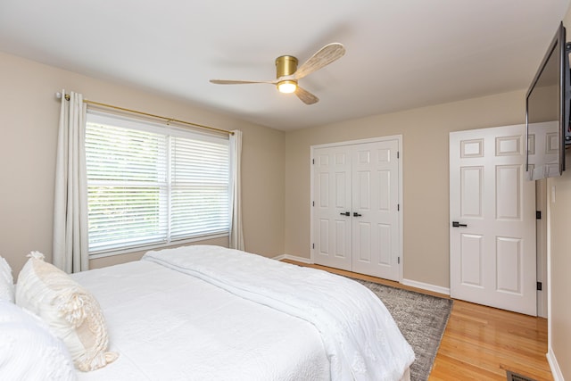 bedroom featuring ceiling fan, a closet, and hardwood / wood-style floors