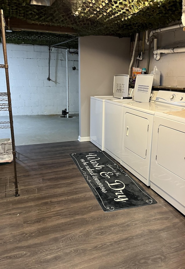 washroom featuring washer and dryer and dark wood-type flooring