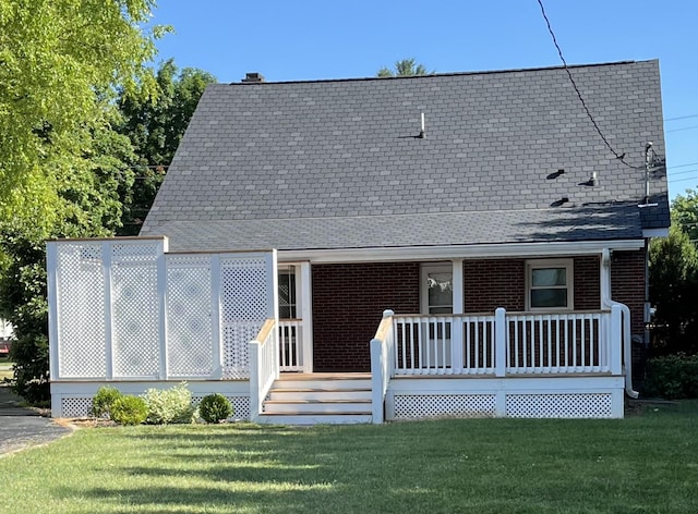 back of property featuring a lawn