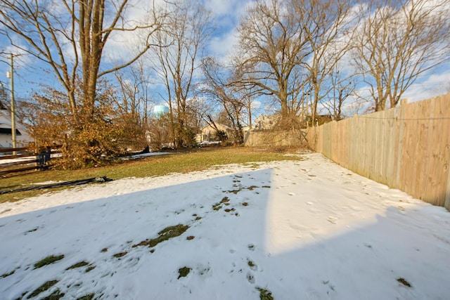 view of yard layered in snow