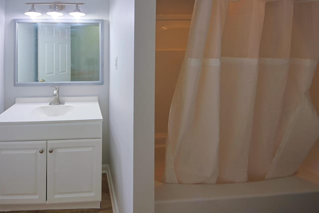 bathroom featuring shower / bath combination with curtain and vanity