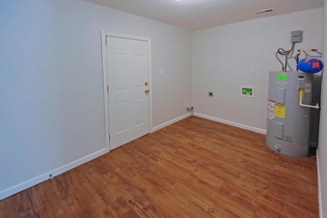 clothes washing area with electric water heater, washer hookup, wood-type flooring, and hookup for an electric dryer