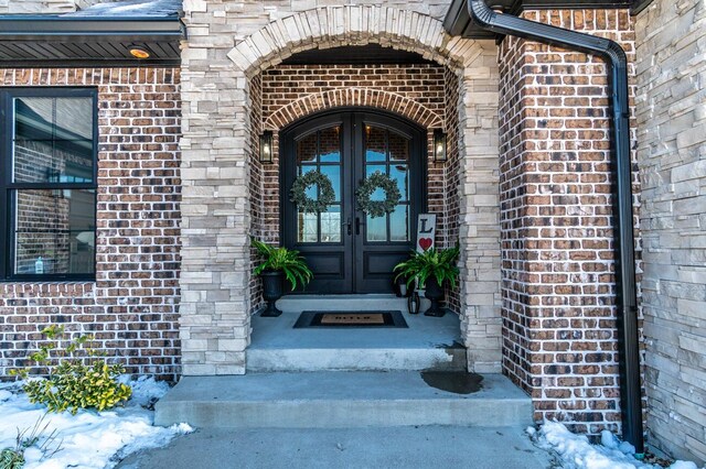 view of front facade featuring brick siding, an attached garage, and stairs