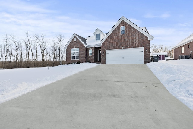 front of property featuring a garage and central AC