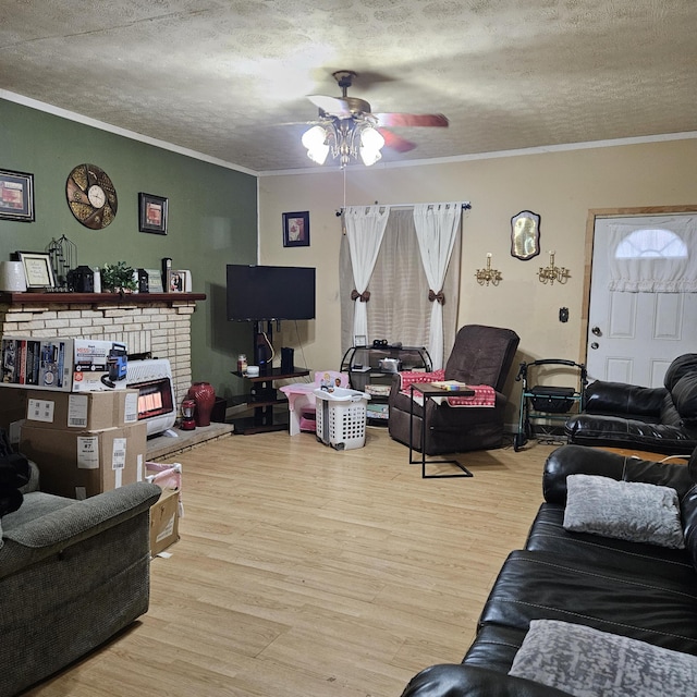 living room featuring a textured ceiling, light hardwood / wood-style flooring, and ornamental molding