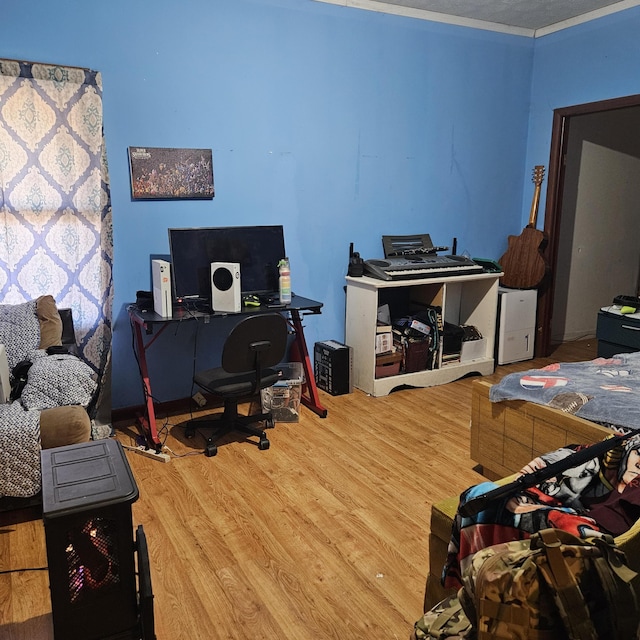 home office featuring hardwood / wood-style floors and crown molding