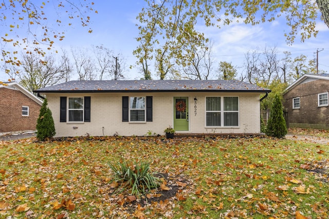 ranch-style home featuring a front yard