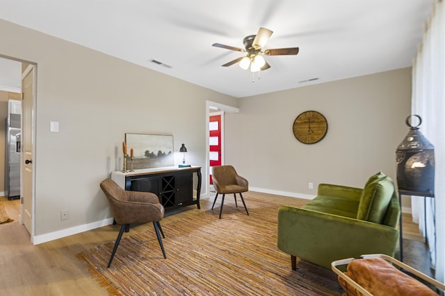 sitting room featuring ceiling fan and light hardwood / wood-style flooring