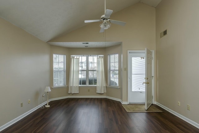 interior space featuring lofted ceiling, ceiling fan, dark wood-type flooring, and a textured ceiling